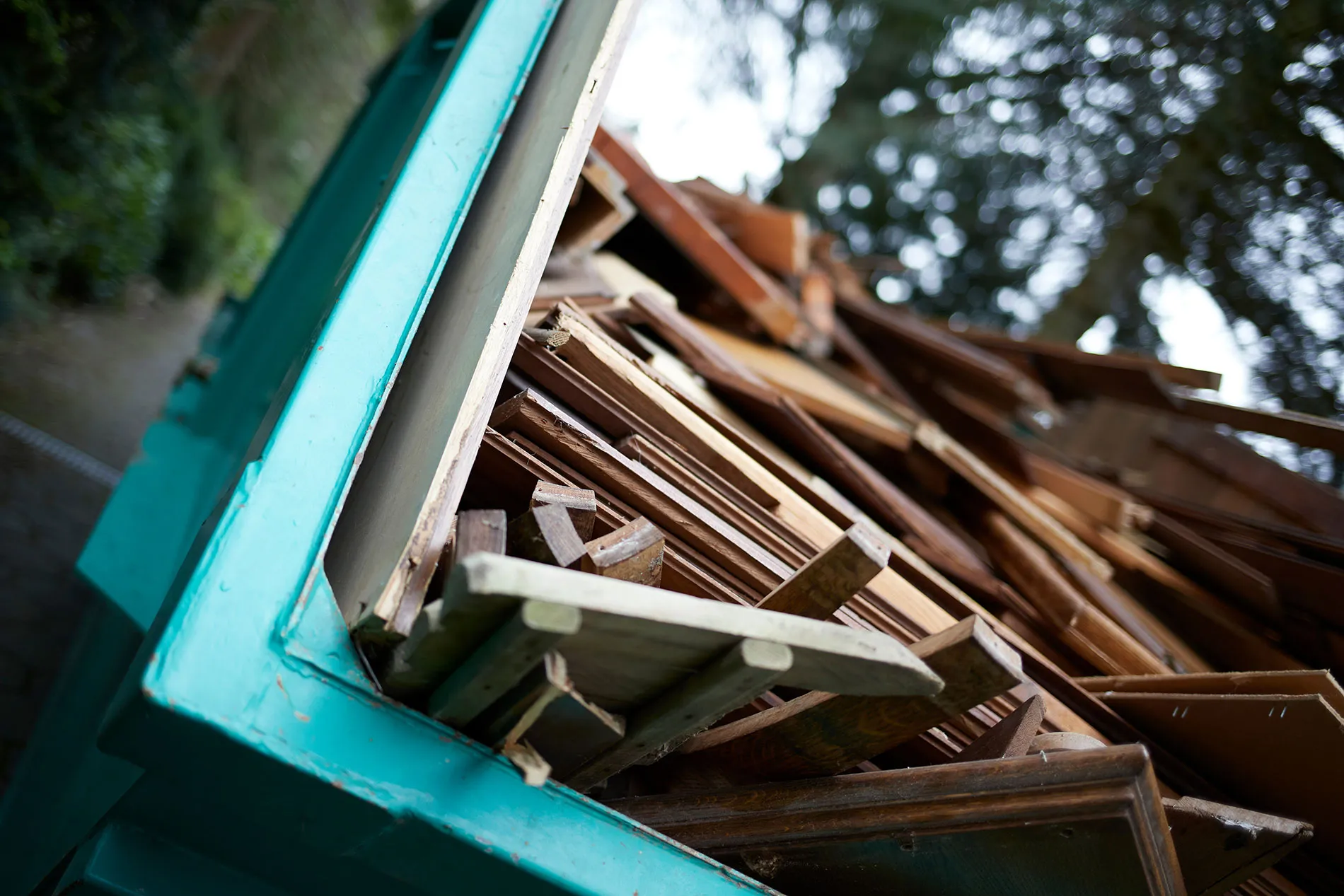 A Light Blue skip full of rubbish