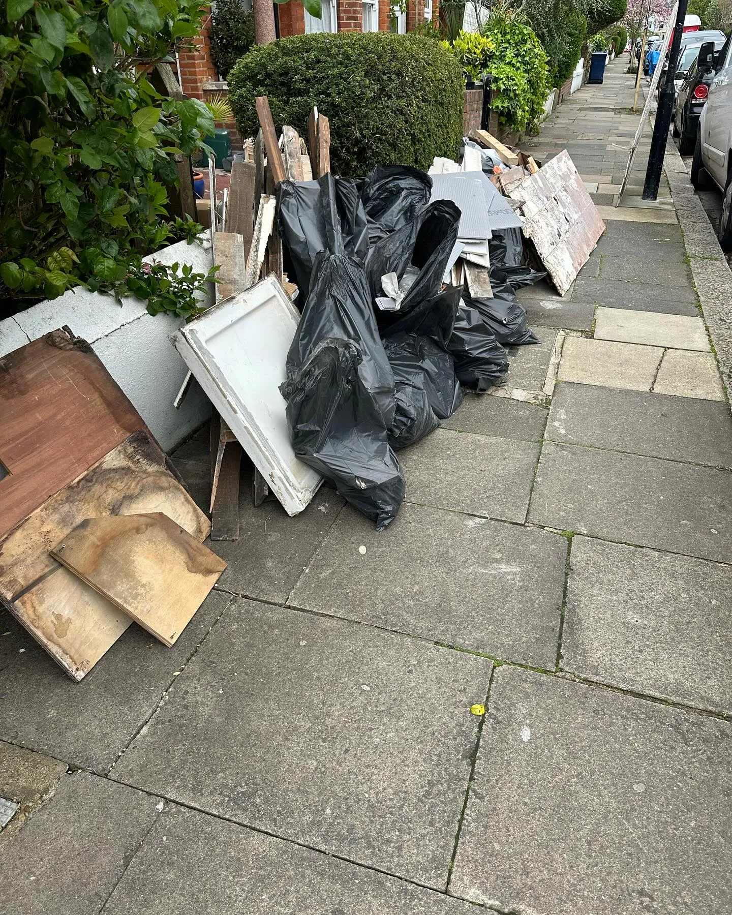 A pile of trash sitting on the side of a road.