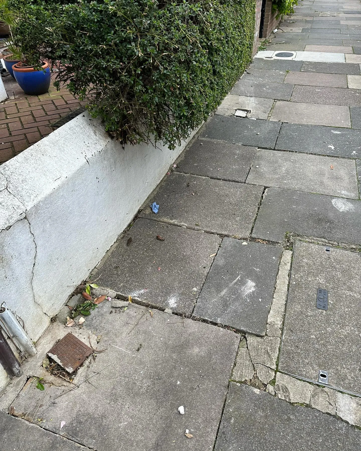 A sidewalk that has a bunch of trash on it.