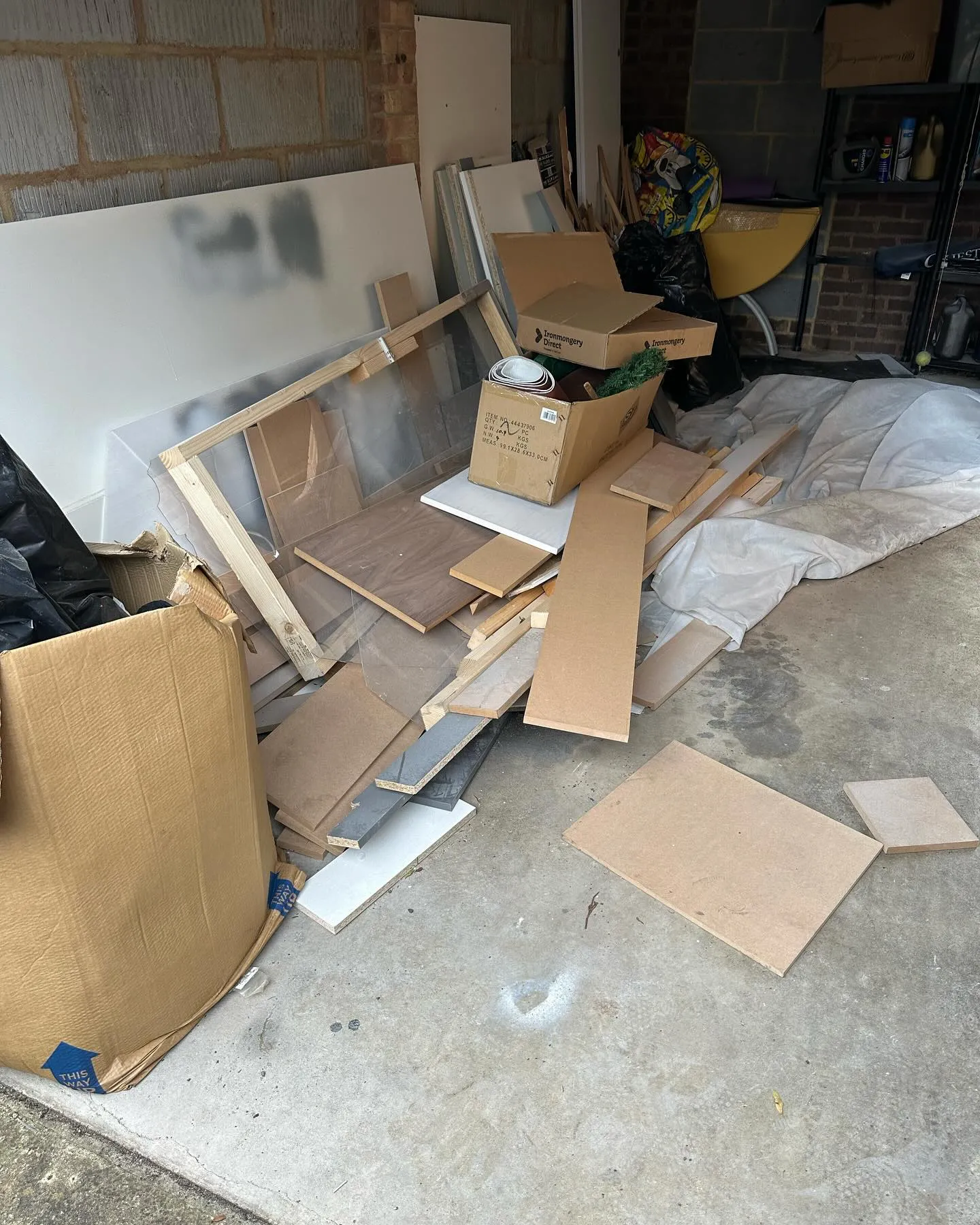 A pile of cardboard sitting on top of a garage floor.