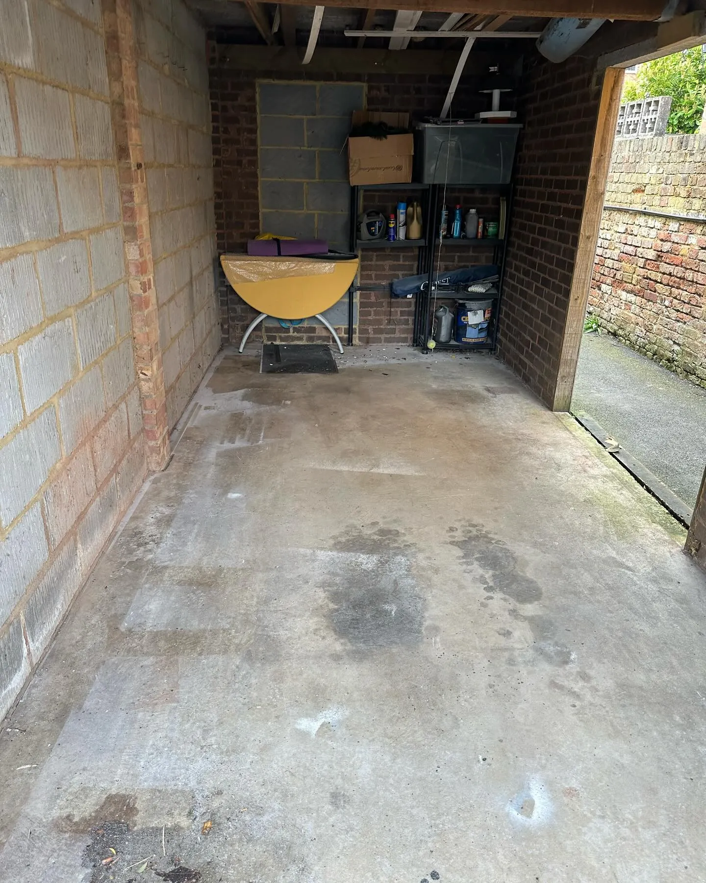 A garage with a yellow boat in it.
