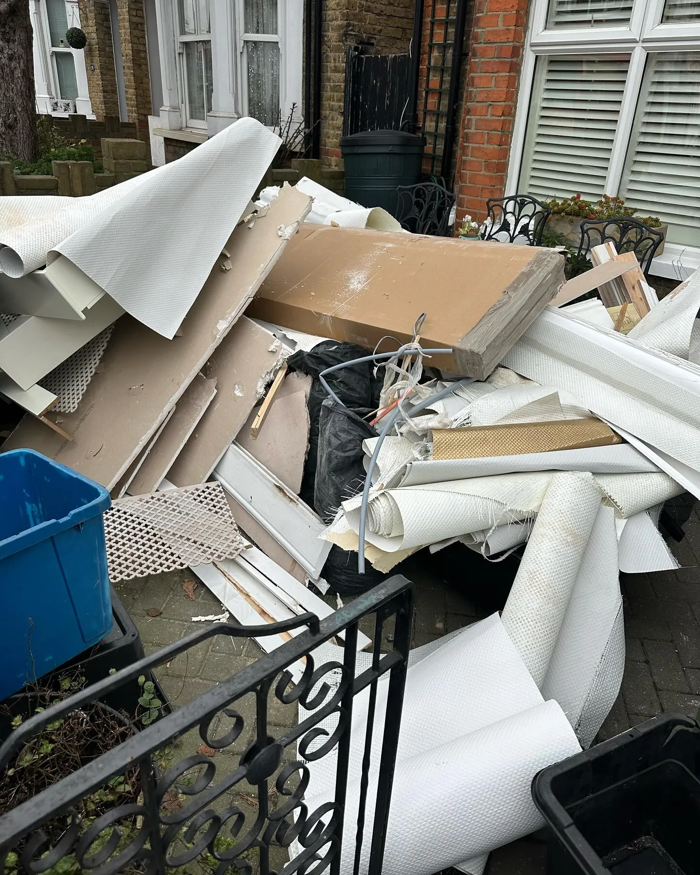 A pile of junk sitting outside of a building.