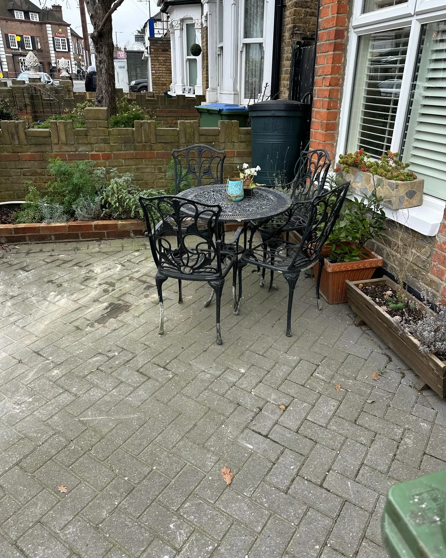 A patio with a table and four chairs.