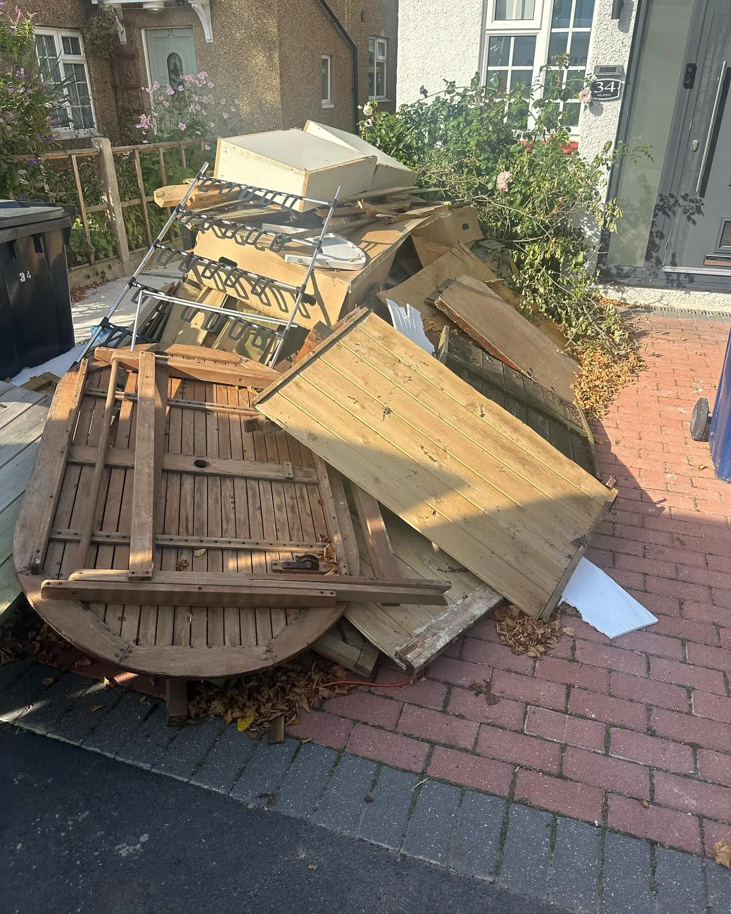 A pile of junk sitting on top of a sidewalk.