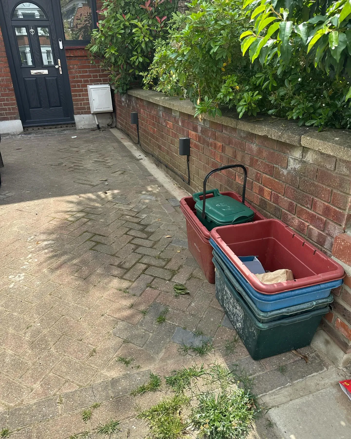 A couple of containers sitting on the side of a road.