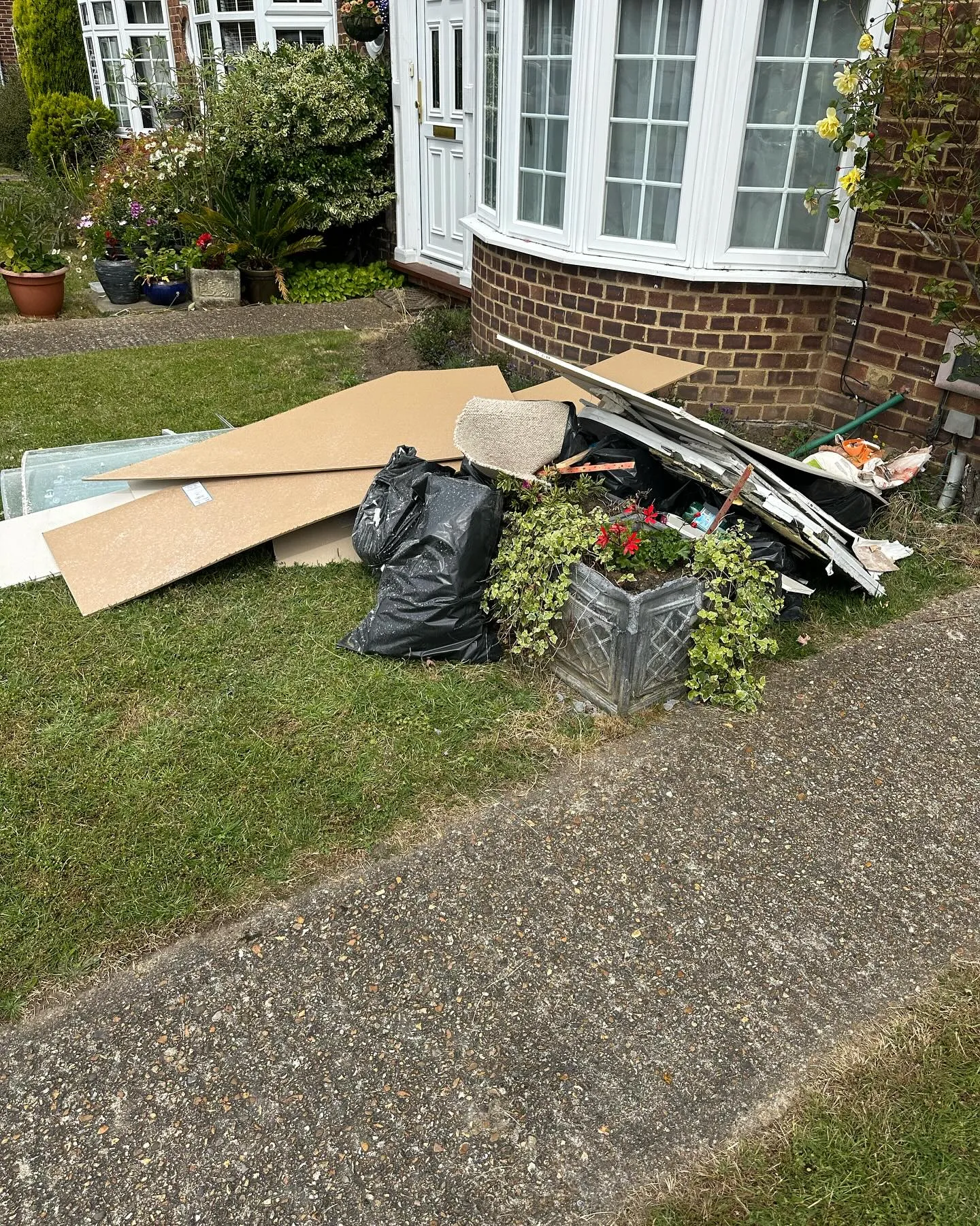 A pile of junk sitting outside of a house.
