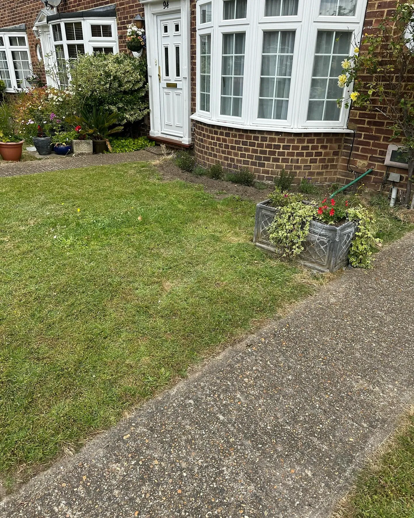 A house with a garden in front of it.